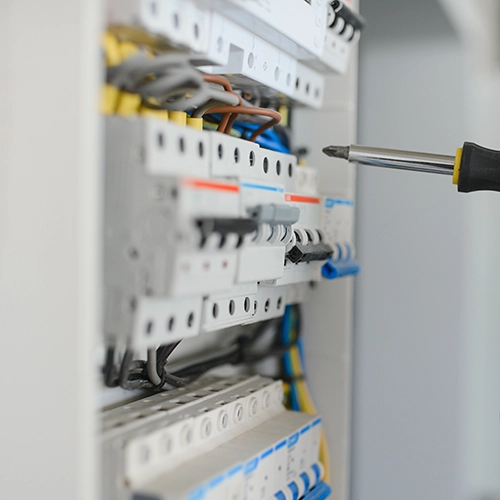Screwdriver fixing a fuse board