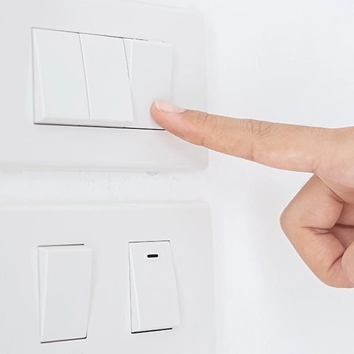 Finger pressing a light switch