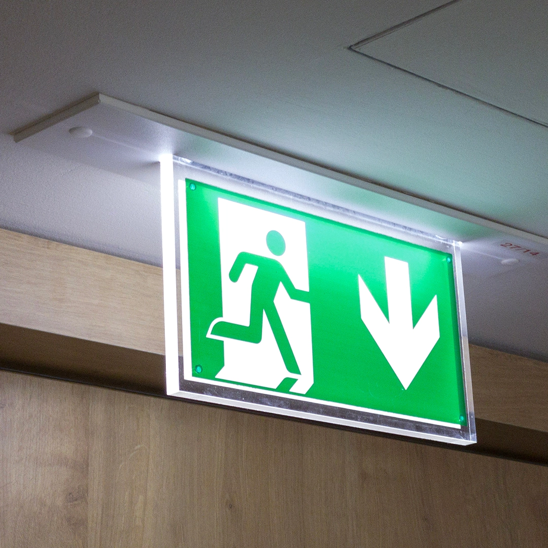 Green fire exit sign with arrow pointing down